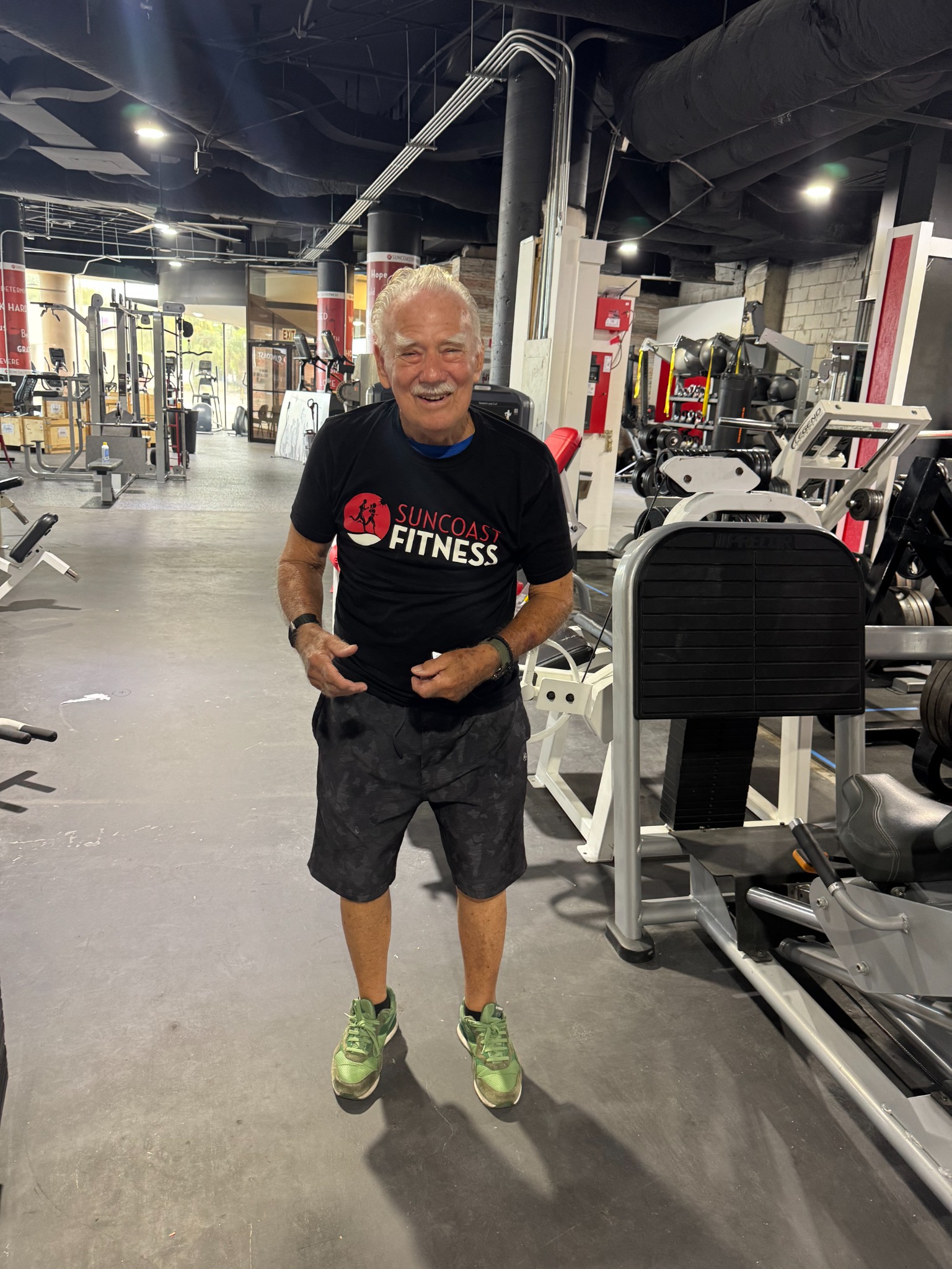 A Suncoast Fitness member smiling inside the new gym