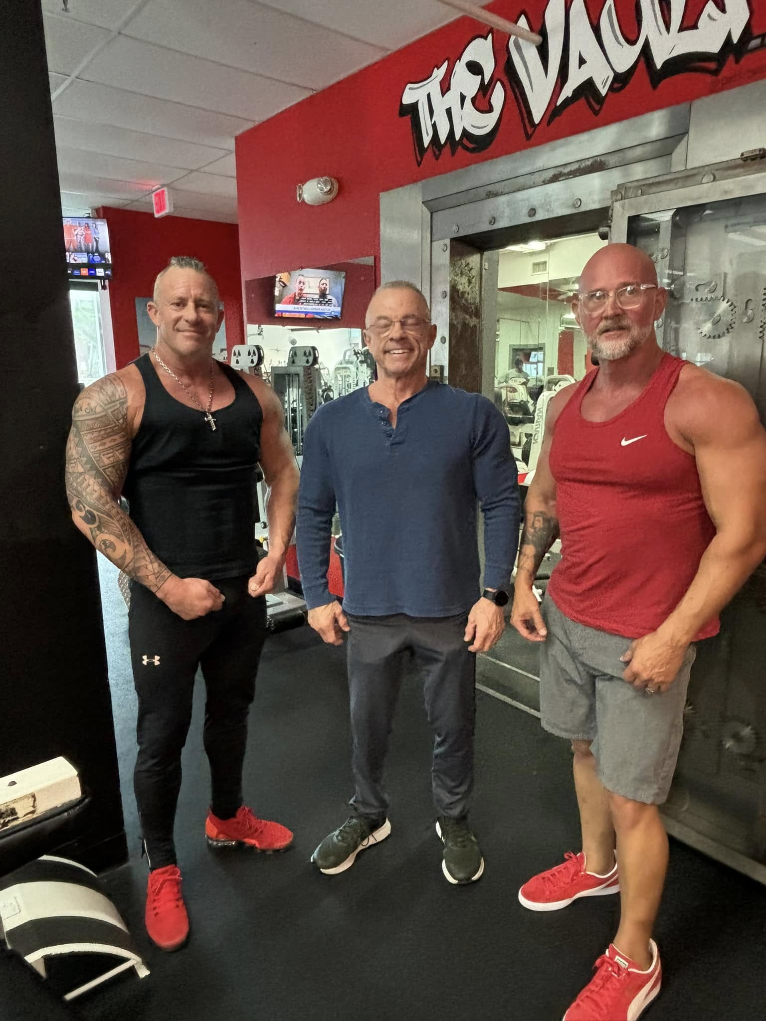 Three Suncoast Fitness members smiling together by the gym vault