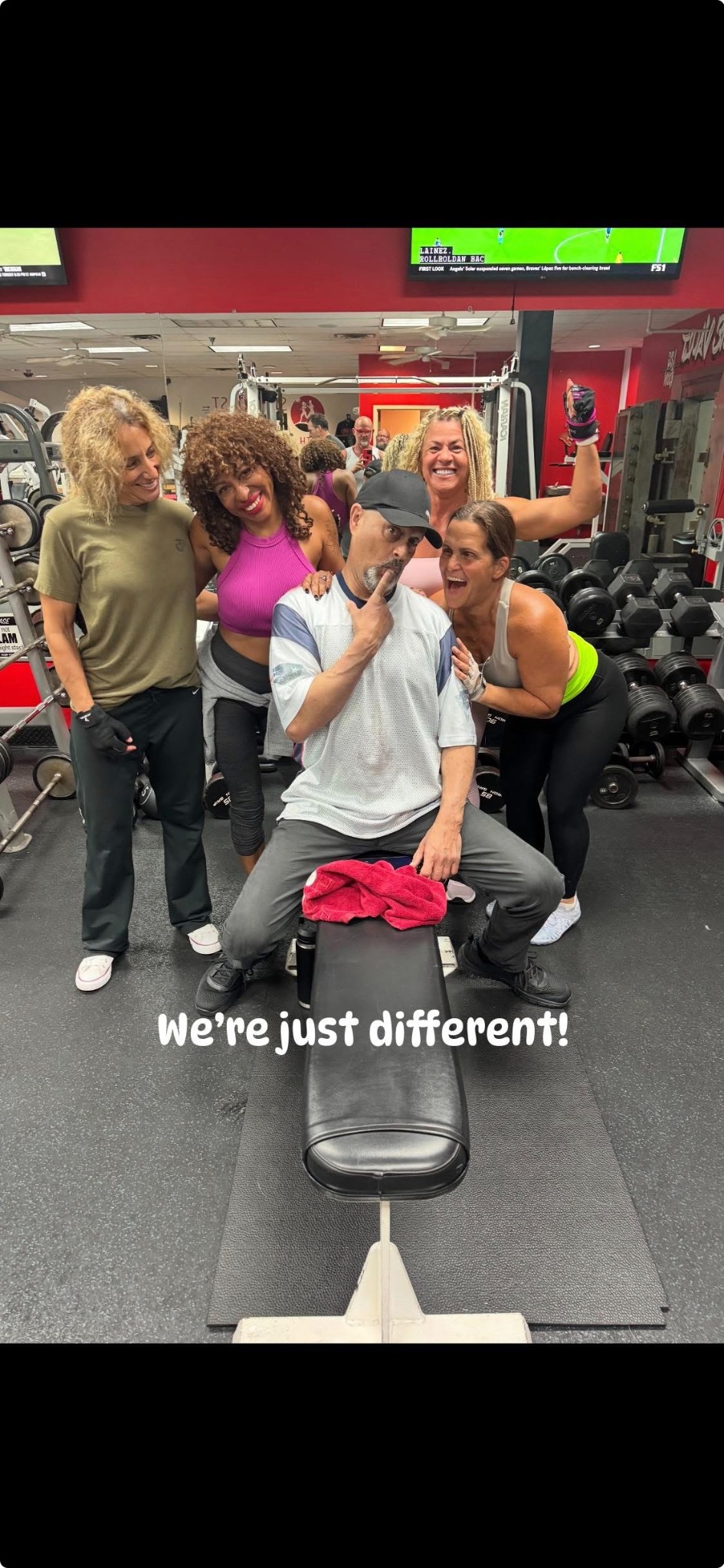 A group of Suncoast Fitness members smiling together in the earlier gym